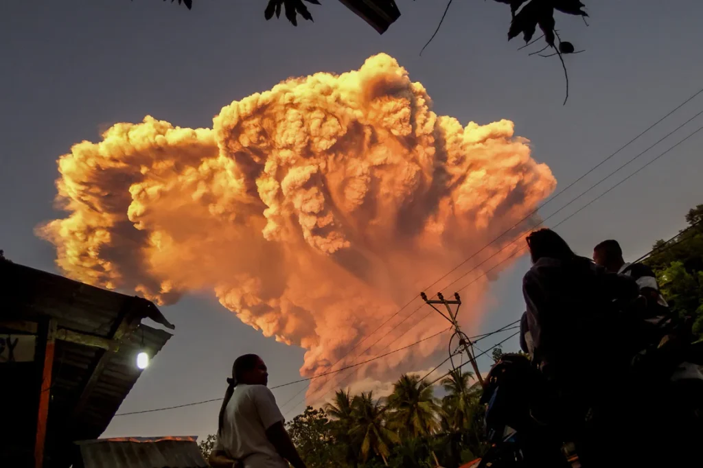 An orange mushroom-shaped cloud dispersed above the village of Talibura in the eruption which could be seen up to 93 miles (150km) away.